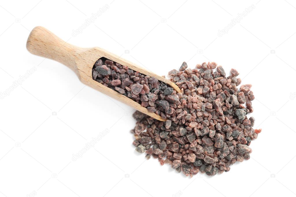 Black salt and wooden scoop on white background, top view