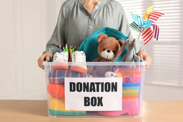 Woman Holding Donation Box Child Goods Indoors Closeup — 图库照片