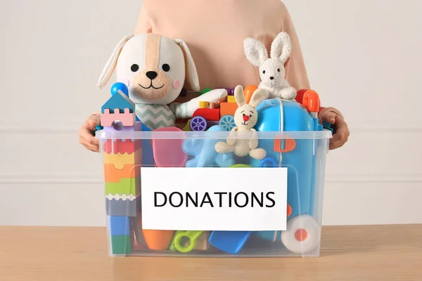 Little Girl Holding Donation Box Toys Light Background Closeup — Stock Photo, Image
