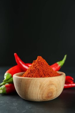 Paprika tozu ve taze biberler siyah masada. Metin için boşluk