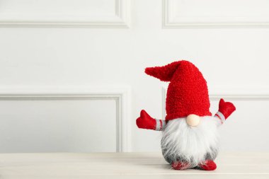 Beyaz ahşap masada şirin bir noel cücesi. Metin için boşluk