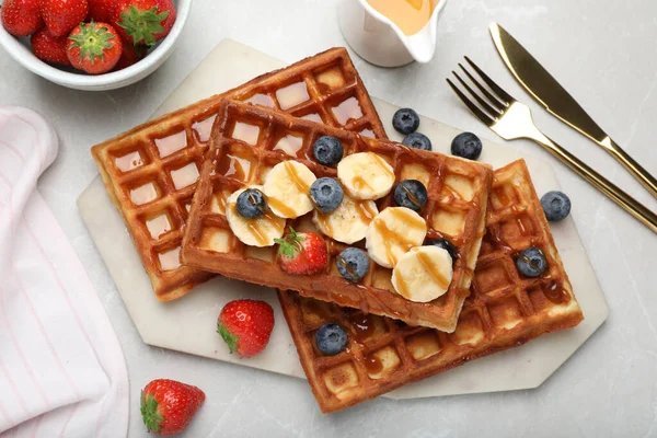 Delicious Belgian Waffles Banana Berries Caramel Sauce Light Marble Table — стокове фото