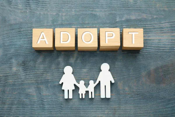 Family Figure Word Adopt Made Cubes Blue Wooden Table Flat — Stockfoto