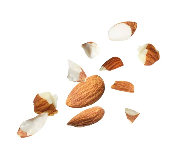 Pieces Tasty Almonds Falling White Background — 图库照片