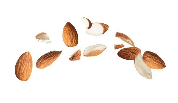 Pieces Tasty Almonds Falling White Background — Stock Photo, Image