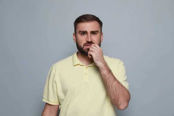 Man Biting His Nails Grey Background Bad Habit — Stock Photo, Image