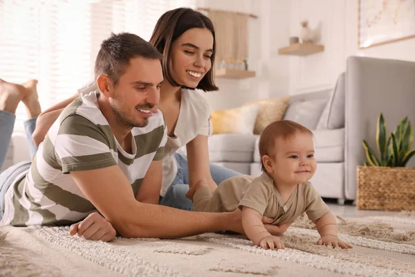 Happy Parents Helping Cute Baby Crawl Floor Home — Stockfoto