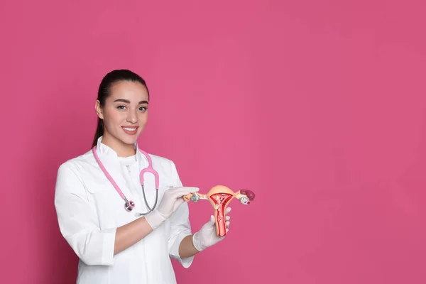 Doctor Demonstrating Model Female Reproductive System Pink Background Space Text — Stockfoto
