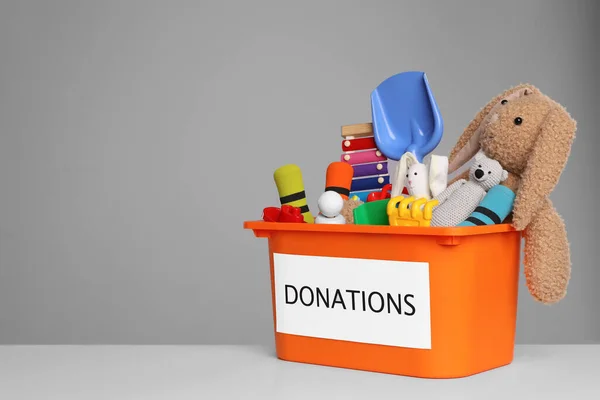 Donation Box Different Toys White Table Grey Background Space Text — 图库照片