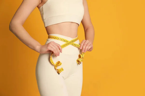 Woman Sportswear Measuring Waist Tape Yellow Background Closeup Space Text — Fotografia de Stock