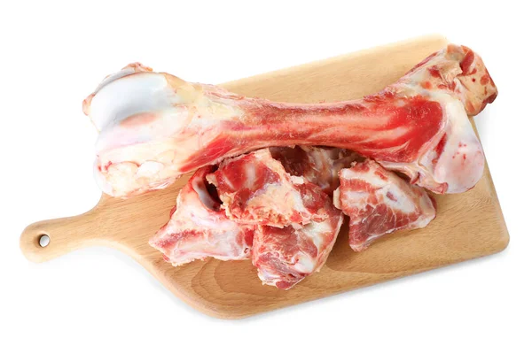 Wooden board with raw meaty bones on white background, top view
