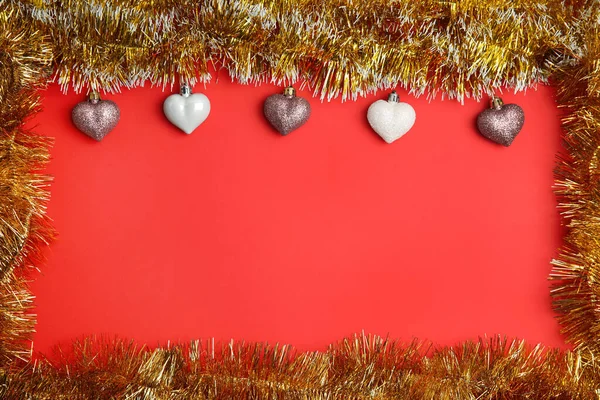 Frame Shiny Golden Tinsel Christmas Baubles Red Background Flat Lay - Stock-foto