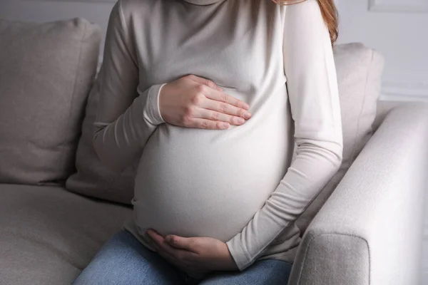 Young Pregnant Woman Sitting Sofa Indoors Closeup — Fotografia de Stock