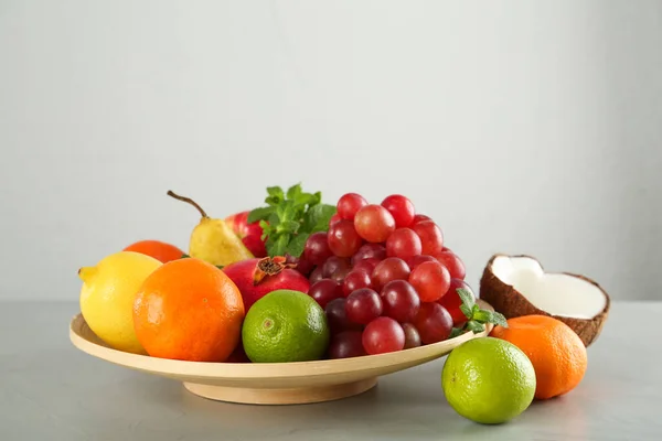 Wooden Plate Different Ripe Fruits Grey Table — Stockfoto