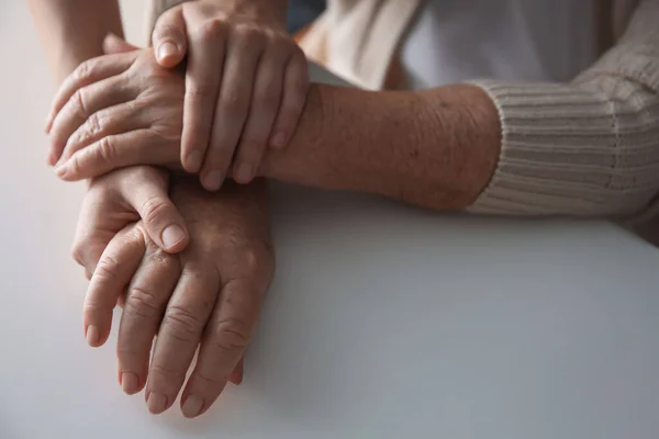 Young Elderly Women Holding Hands Together White Table Closeup — Stock Photo, Image