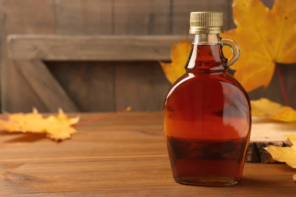 Bottle Tasty Maple Syrup Dry Leaves Wooden Table Space Text — Stock Photo, Image