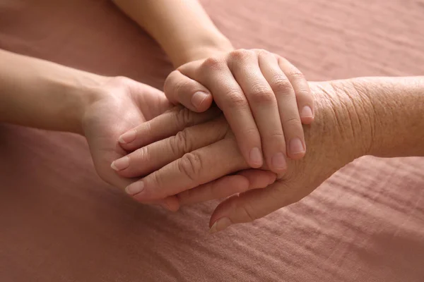 Young Elderly Women Holding Hands Together Pink Fabric Closeup — Stock Photo, Image