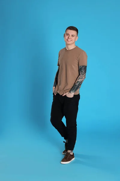 Smiling Young Man Tattoos Light Blue Background — Foto Stock