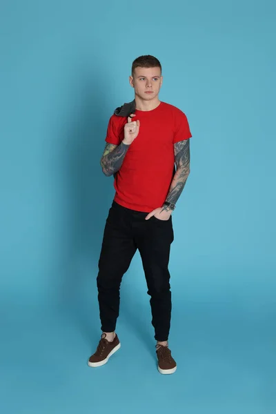 Young Man Tattoos Light Blue Background — Stockfoto