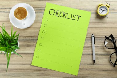 Paper sheet with inscription Checklist, alarm clock, plant, cup of coffee and eyeglasses on wooden table, flat lay