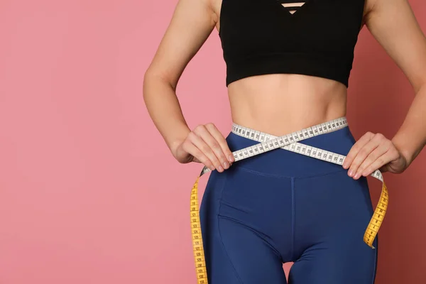 Woman Sportswear Measuring Waist Tape Pink Background Closeup Space Text — стоковое фото