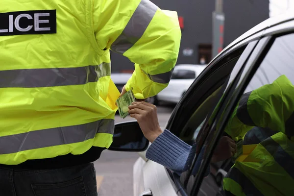 Woman Putting Bribe Police Officer Pocket Out Car Window Closeup — Φωτογραφία Αρχείου