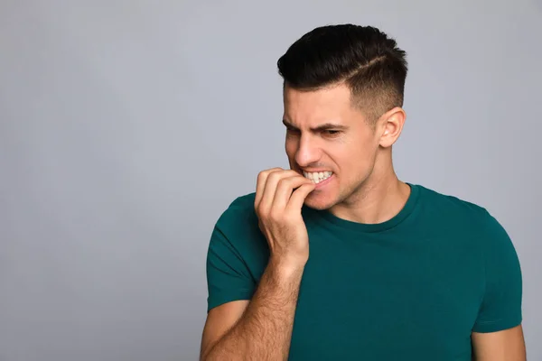 Man Biting His Nails Grey Background Space Text Bad Habit — Stock Photo, Image