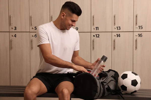 Handsome Man Taking Bottle Sports Bag Locker Room — Fotografia de Stock