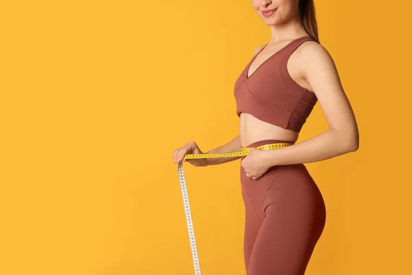Happy Woman Sportswear Measuring Waist Tape Yellow Background Closeup Space —  Fotos de Stock