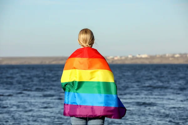 Woman Wrapped Bright Lgbt Flag River Back View — Stockfoto