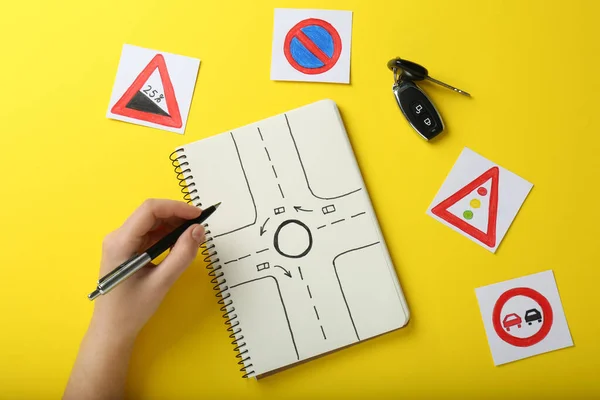 Woman Workbook Driving Lessons Road Signs Yellow Background Top View — Fotografia de Stock