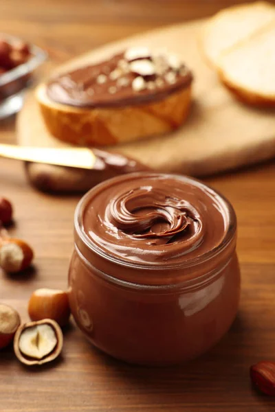 Glass Jar Tasty Chocolate Hazelnut Spread Nuts Wooden Table — 图库照片