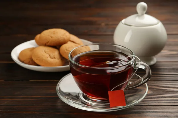 Tea Bag Glass Cup Hot Water Cookies Wooden Table — стоковое фото
