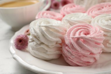 Plate with delicious marshmallows on white table, closeup