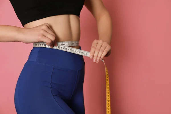 Woman Sportswear Measuring Waist Tape Pink Background Closeup Space Text — Stockfoto