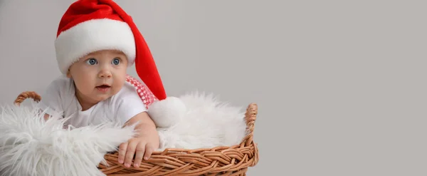 Cute Baby Wearing Santa Hat Wicker Basket Light Grey Background — Stockfoto