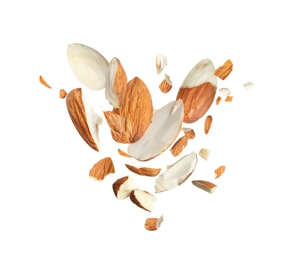 Pieces Tasty Almonds Falling White Background — Stock Photo, Image