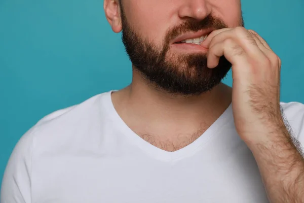 Man Biting His Nails Light Blue Background Closeup Bad Habit — Stock Photo, Image