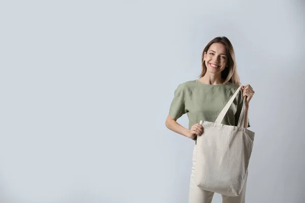 Happy Young Woman Blank Eco Friendly Bag Light Background Space — стоковое фото