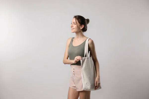 Happy Young Woman Blank Eco Friendly Bag Light Background — Fotografia de Stock
