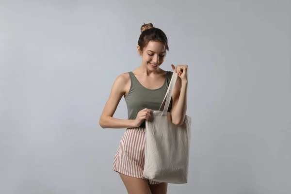 Happy Young Woman Blank Eco Friendly Bag Light Background — Stockfoto