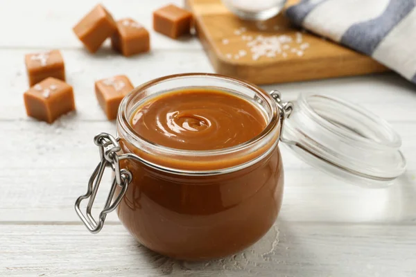 Yummy Salted Caramel Glass Jar Candies White Wooden Table — Photo