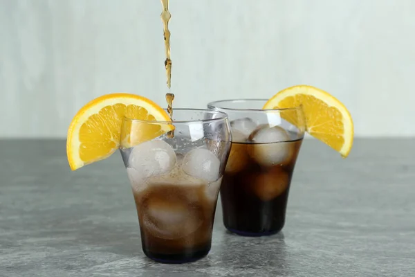 Pouring Cocktail Glass Orange Ice Balls Grey Table — Stock Fotó