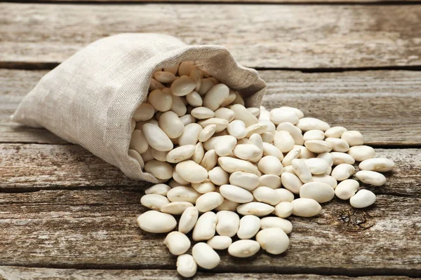 Overturned Sack White Beans Wooden Table — Foto Stock
