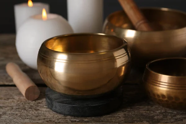 Golden Singing Bowls Mallets Burning Candles Wooden Table Closeup — 스톡 사진