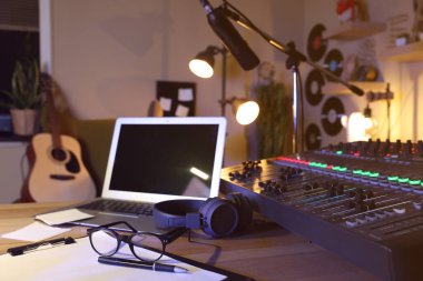 Professional audio equipment on table in modern radio studio