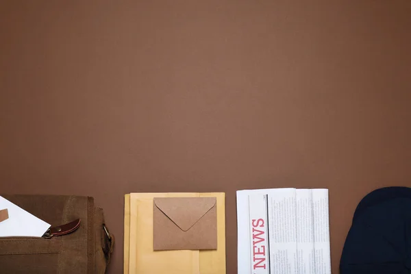 Postman Hat Bag Newspapers Mails Brown Background Flat Lay Space — Stockfoto