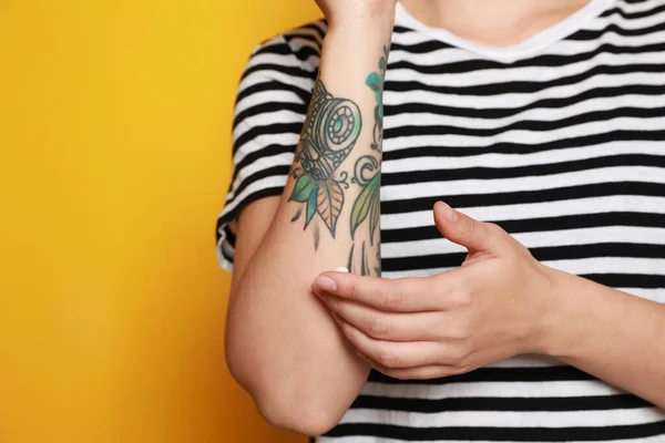 Woman Applying Cream Her Arm Tattoos Yellow Background Closeup Space — Photo