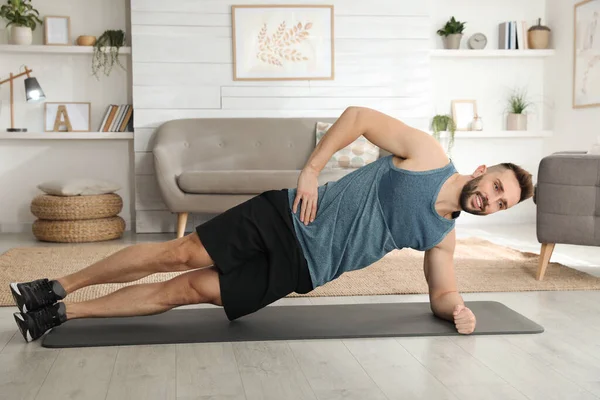 Handsome Man Doing Side Plank Exercise Yoga Mat Home — Stok fotoğraf