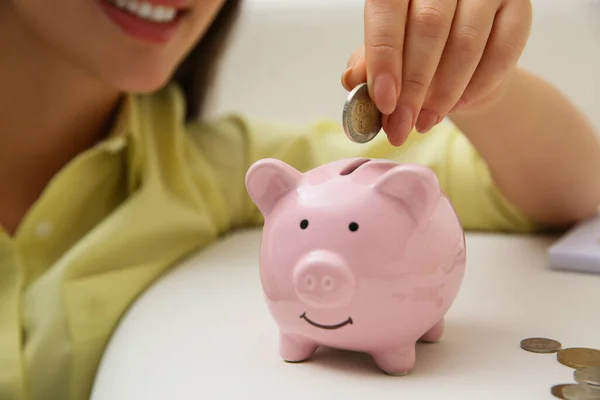 Woman Putting Coin Piggy Bank Indoors Closeup Money Savings — Fotografia de Stock